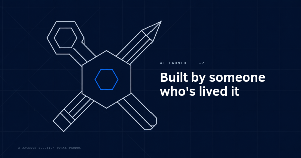Faceted hard hat over crossed angular tools with a hexagonal wrench head, representing a builder's hands-on background